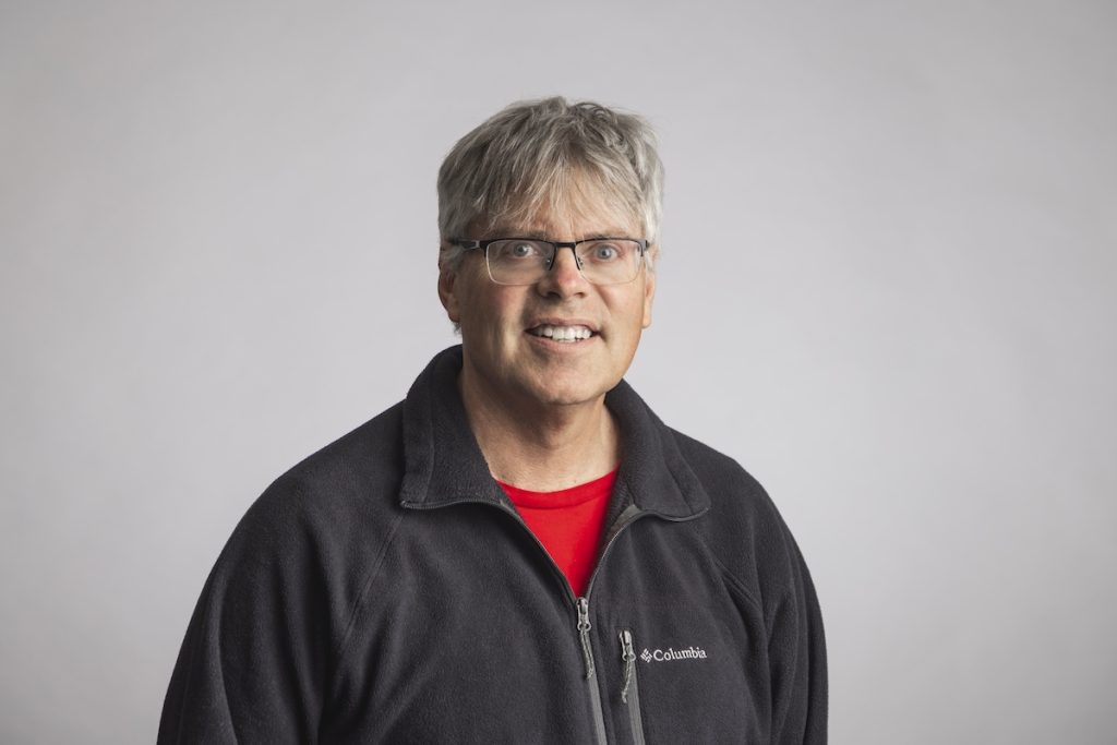 Photo of man with white hair and glasses